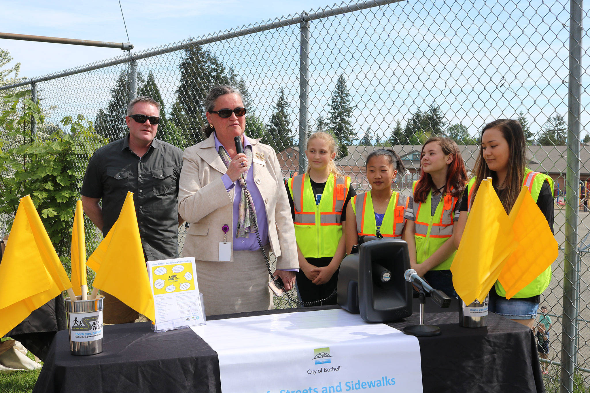 Bothell Mayor Andy Rheaume and Northshore School District (NSD) Superintendent Michelle Reid celebrate the installation of pedestrian flags at a variety of intersections near NSD schools alongside Frank Love Elementary School students. CATHERINE KRUMMEY / Bothell Reporter