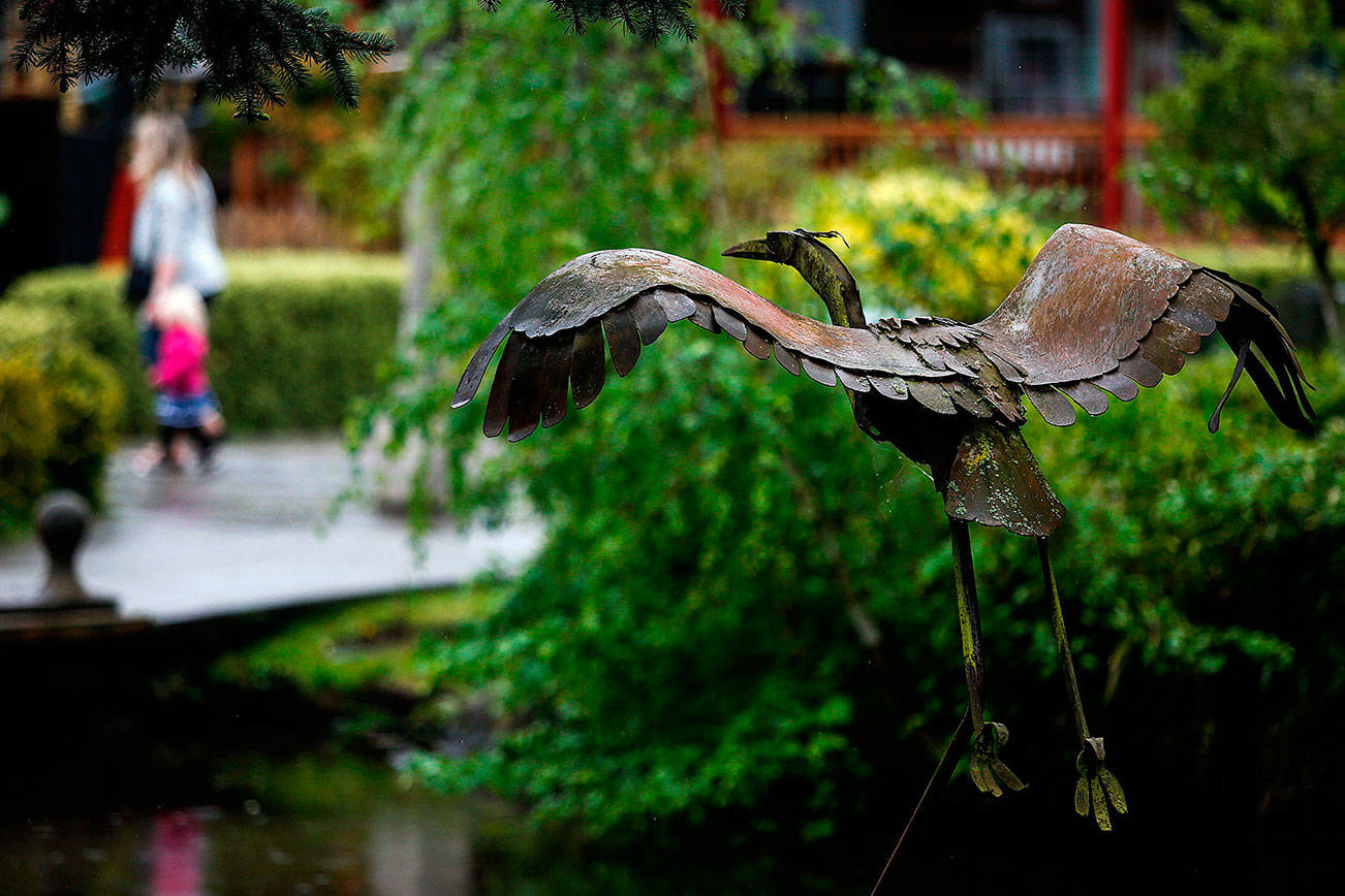 Even on a rainy afternoon such as Thursday, sights and sounds around Bothell’s Country Village are friendly and inviting. (Dan Bates / The Herald)