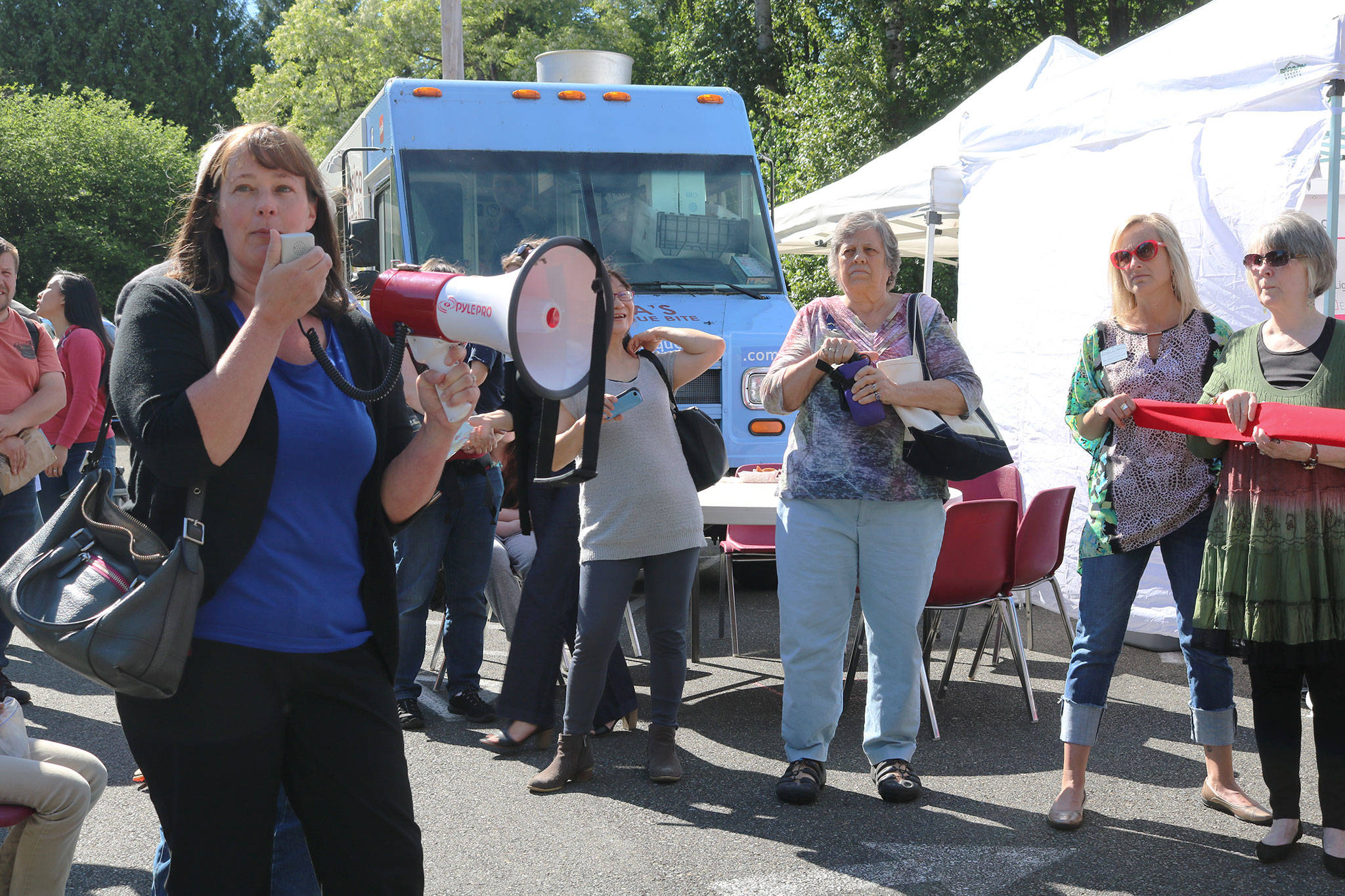 Kenmore City Councilmember Stacey Denuski addresses the crowd at the Kenmore Community Market opening. CATHERINE KRUMMEY / Bothell-Kenmore Reporter