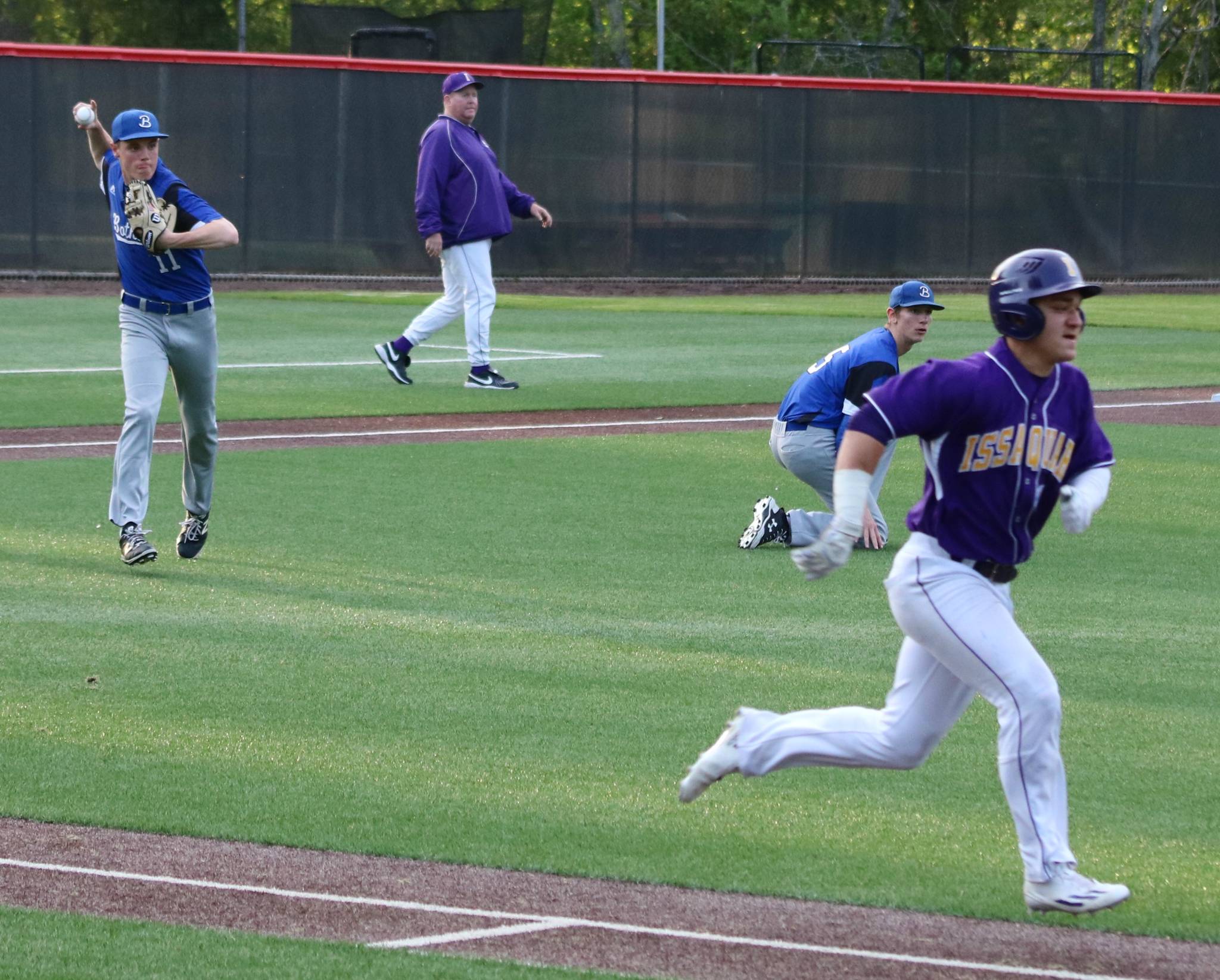 Bothell all-league third baseman Brody Ponti, left, fires out a runner at first during the playoffs. Andy Nystrom, Bothell-Kenmore Reporter