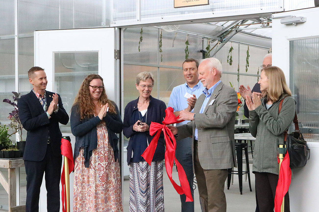 Bastyr University and other local officials participate in a ribbon-cutting ceremony for the college’s new greenhouse. CATHERINE KRUMMEY / Bothell-Kenmore Reporter