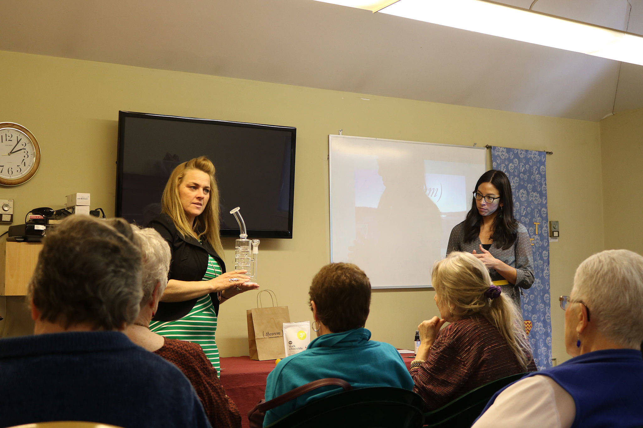 Theorem Cannabis manager Audria Jaggers and operations manager Erin Green give a presentation at the Kenmore Senior Center. CATHERINE KRUMMEY / Bothell-Kenmore Reporter