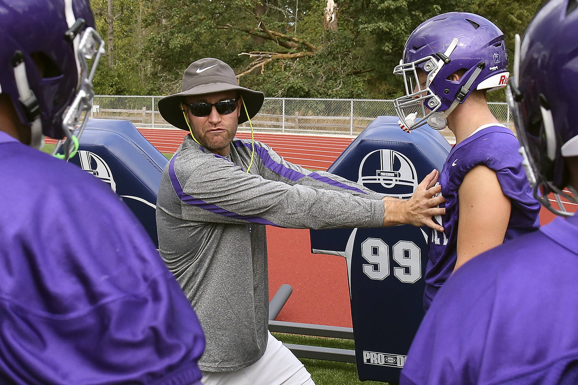 Kevin Clark / The Herald Torrey Myers, the head football coach at North Creek High School, instructs players during practice Friday at the school.