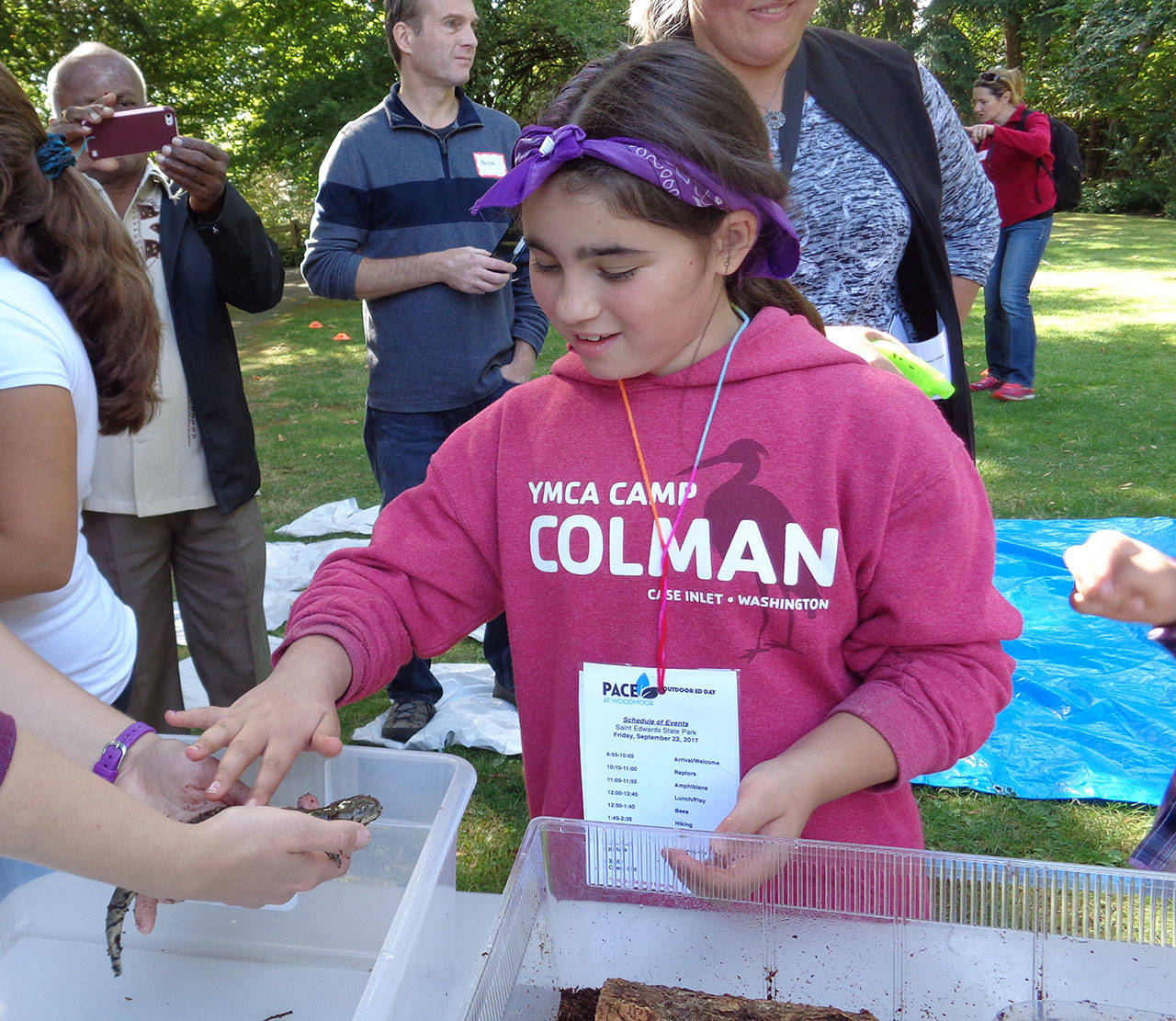 Lily DiGioia, 9, pets a salamander during Outdoor Education Day on Sept. 22. Courtesy of PACE at Woodmoor