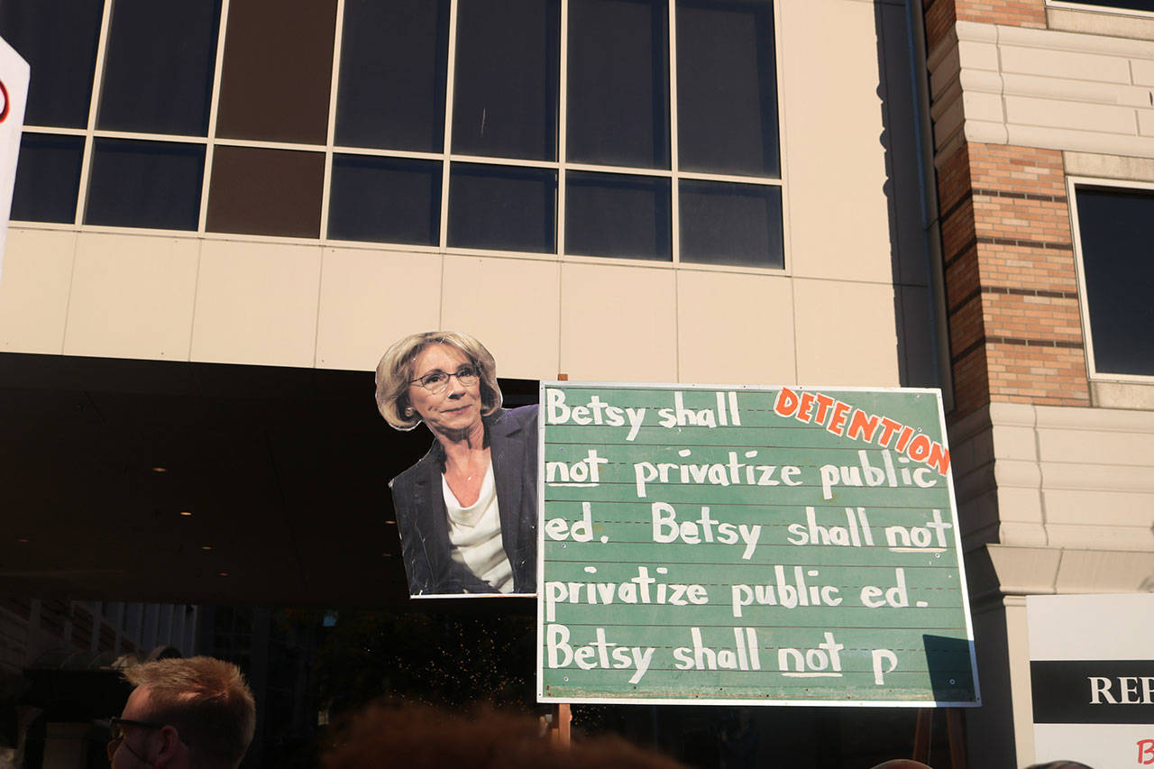 Signs used an educational theme to ridicule DeVos for her policies. Nicole Jennings/staff photo