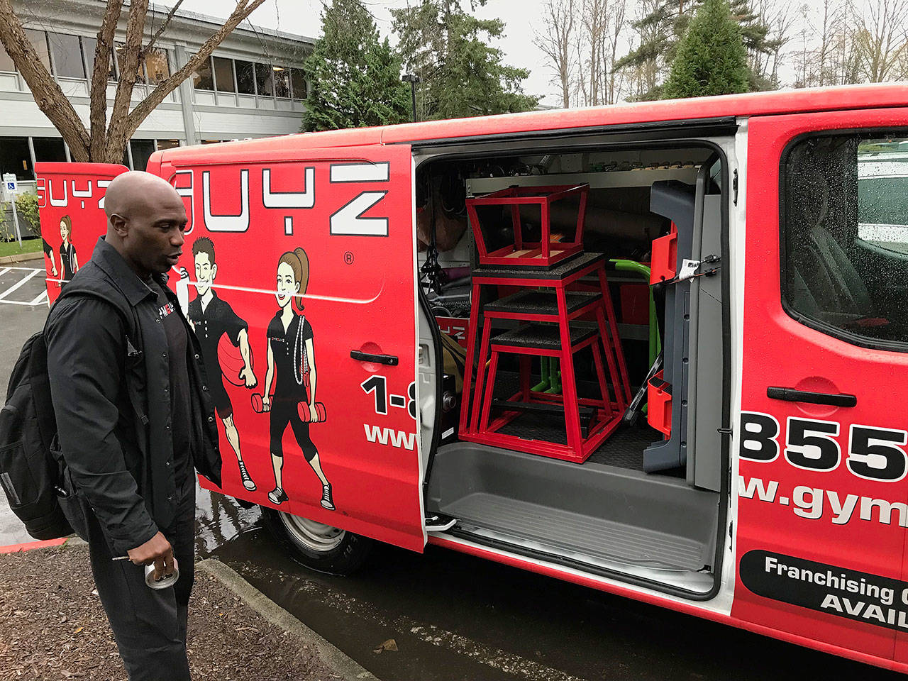 Stacy Edwards, owner of the Eastside GYMGUYZ franchise, opens his van to show the various equipment his trainers use with their clients. Kailan Manandic, Kirkland Reporter