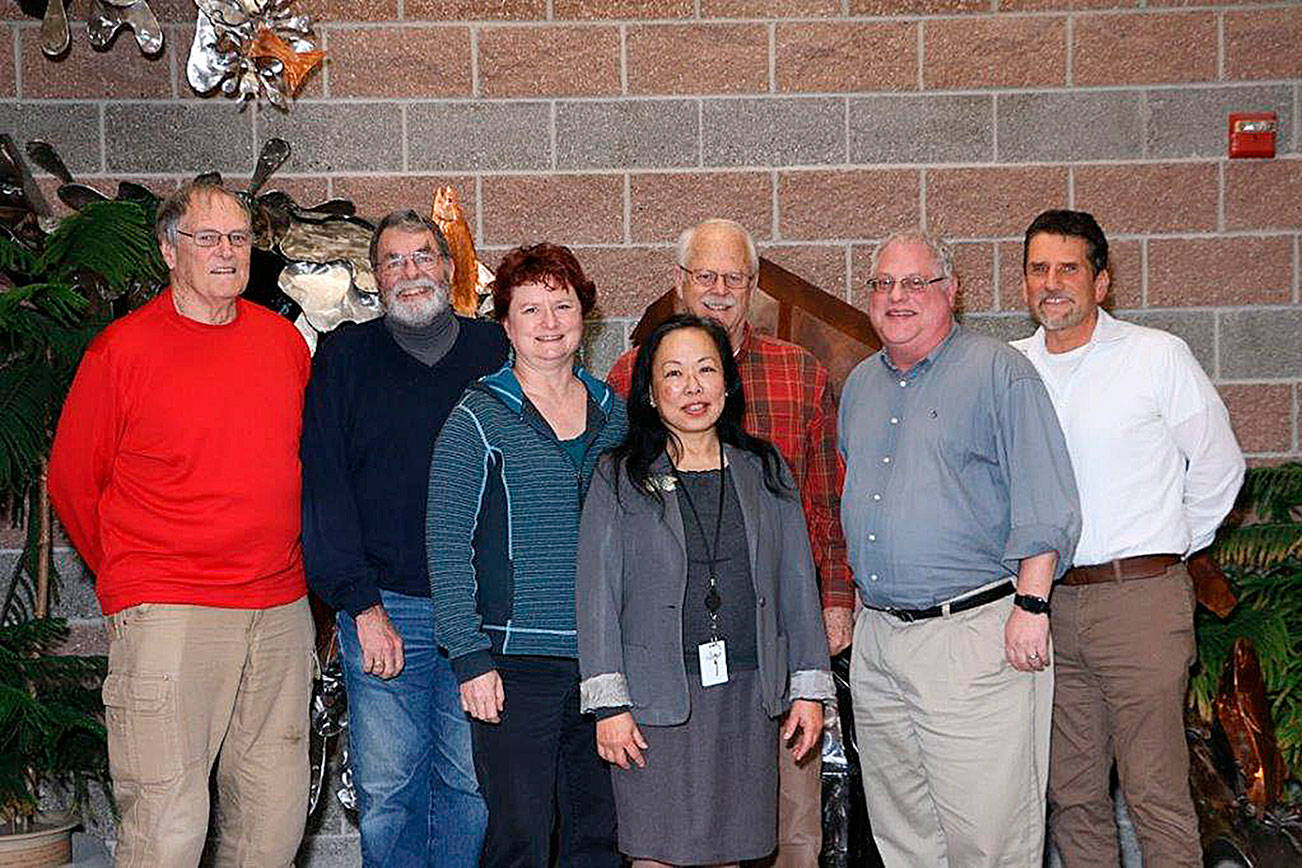 Fanny Yee (Center) stands among the Northshore Utility District Board of Commissioners along with Al Nelson (right), who is the incoming general manager. &lt;em&gt;Courtesy of the Northshore Utility District&lt;/em&gt;