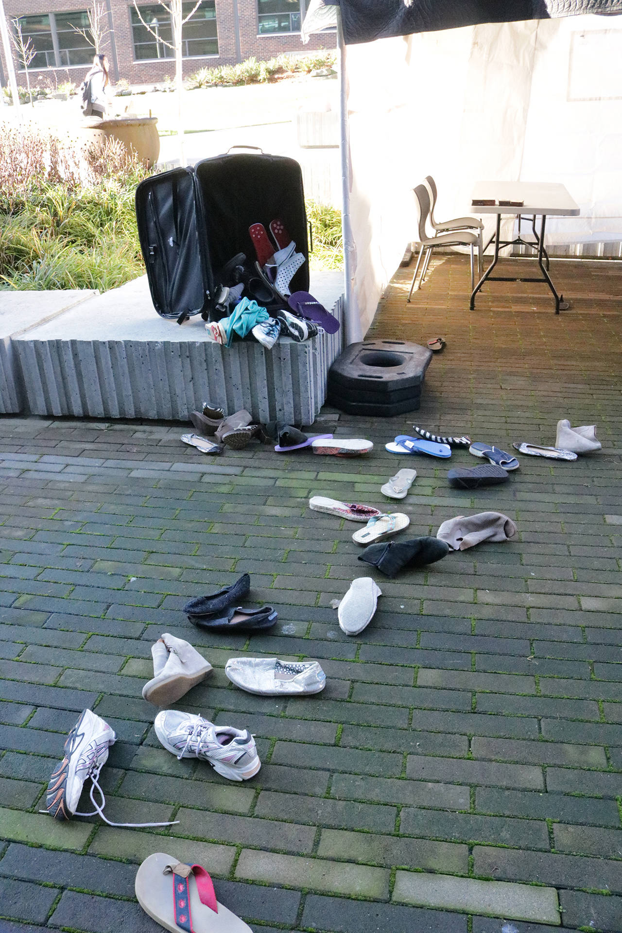 Shoes scattered outside the “American Refugee” tent on the UW Bothell campus. Samantha Pak, Bothell/Kenmore Reporter