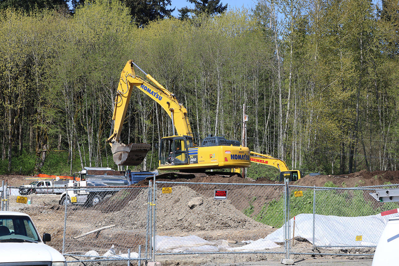 Country Village sat on 13 acres in north Bothell, but around 6 acres were sold to developers who are building more than 90 townhomes on the land. An excavator crew is pictured at work here on a recent afternoon. Aaron Kunkler/Staff Photo