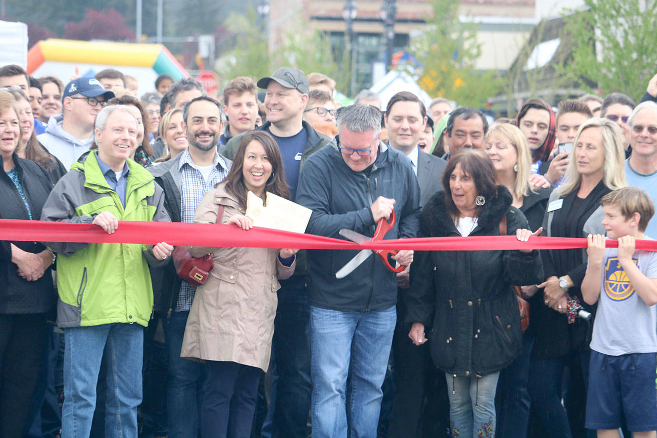 Mayor Rheaume cuts the ribbon after a group countdown from the crowd. Evan Pappas/Staff Photo