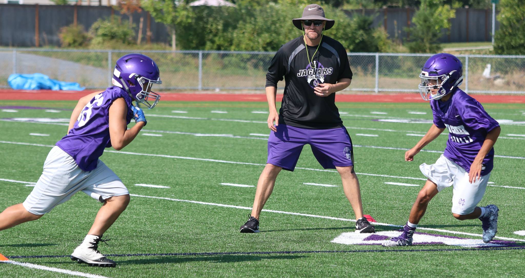 North Creek head coach Torrey Myers eyes two of his players at practice on Aug. 17. Andy Nystrom / staff photo