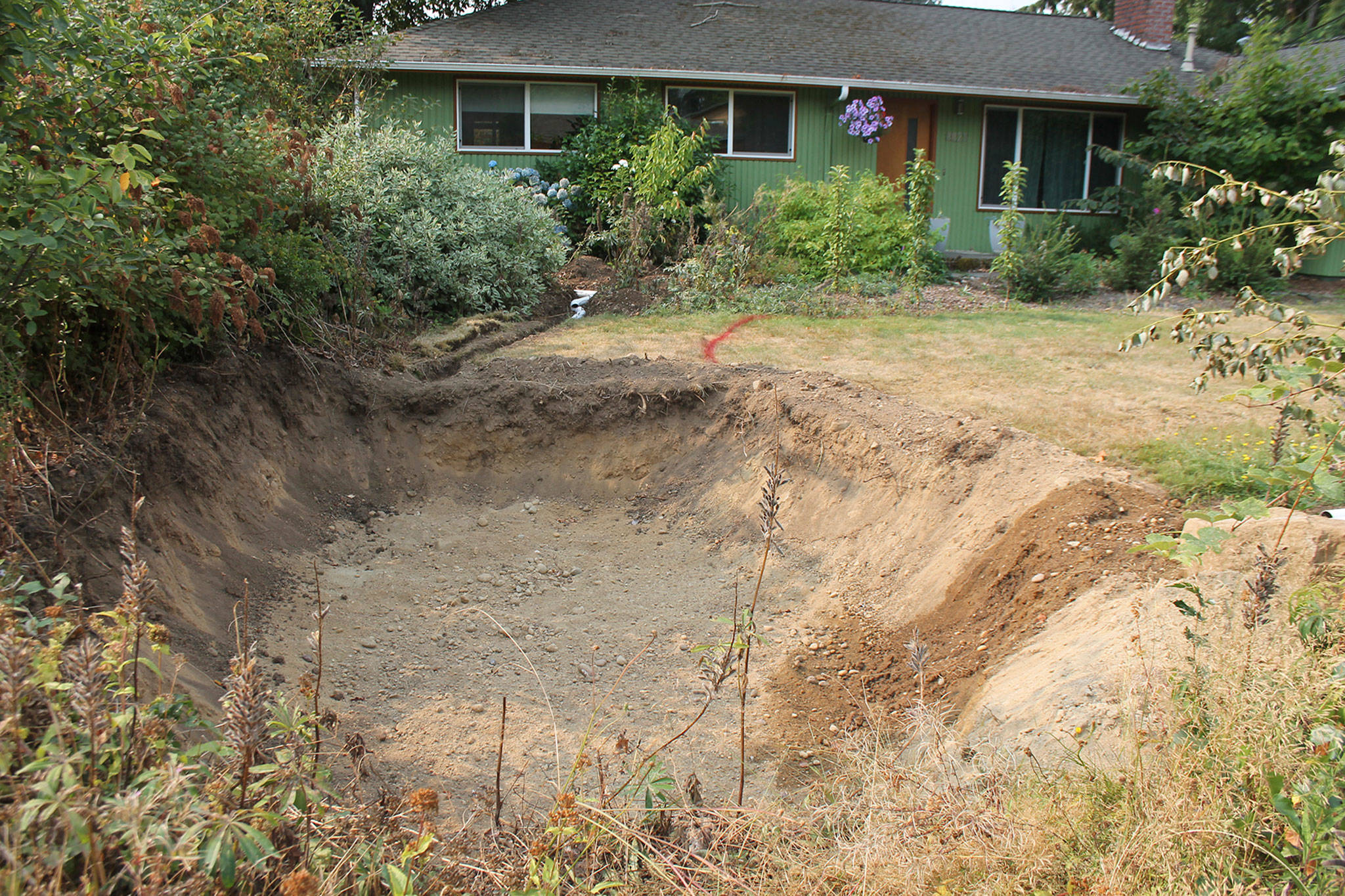The first step in building a rain garden is to dig a hole and remove the soil. Katie Metzger/staff photo