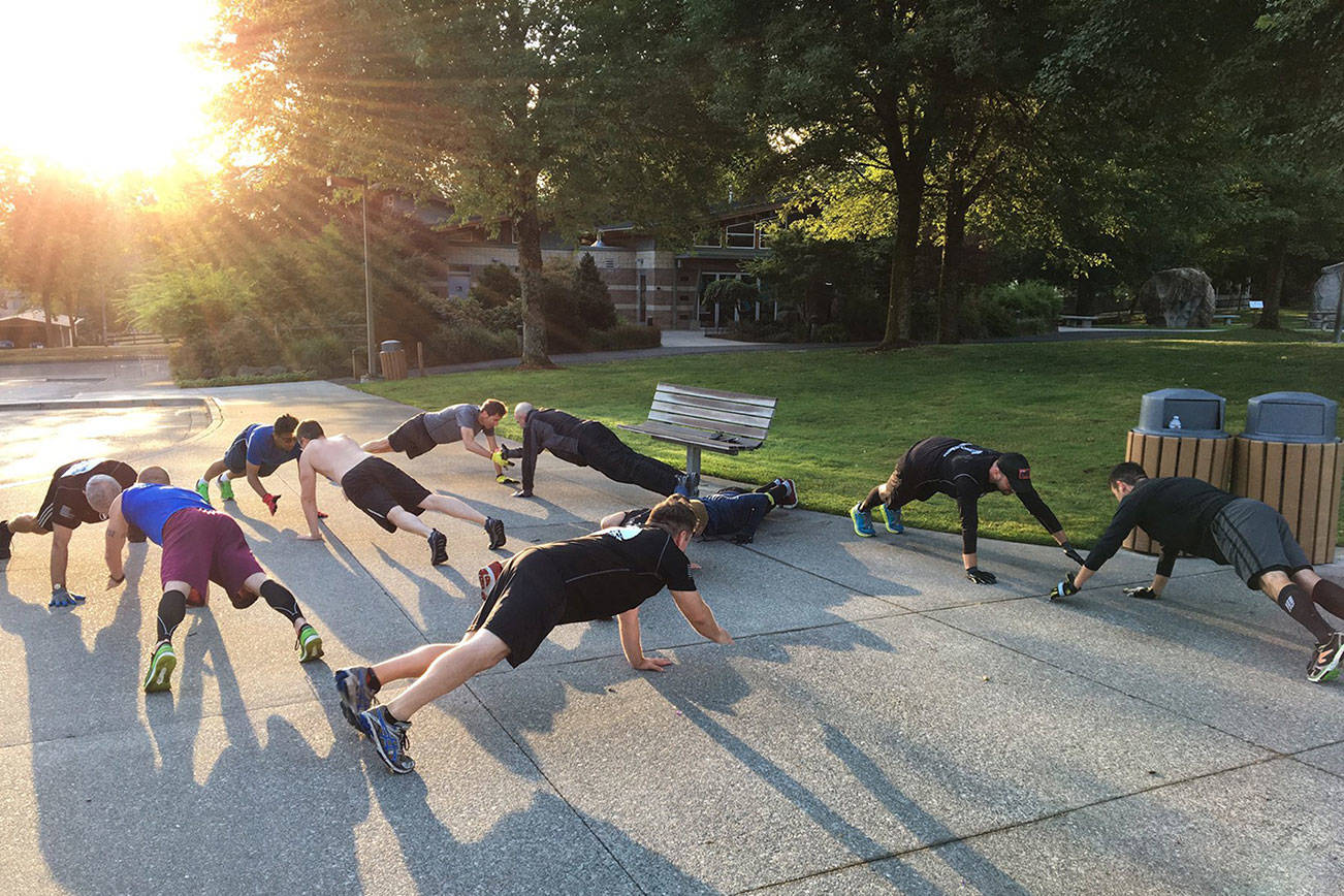 A group of F3 members perform “Handslap Merkins” as they wait for the other group to return from a run around the parking lot. Photo Courtesy of Brian “Dilfer” Gawthrop