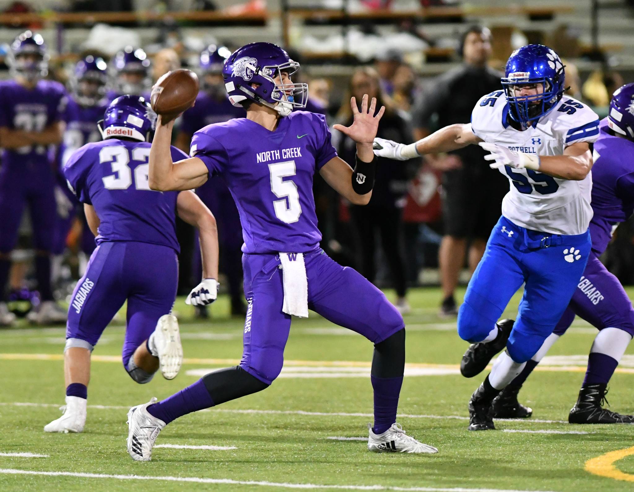 North Creek quarterback Jack Charlton unleashes a pass while Bothell’s Gage Potter closes in. Photo courtesy of Greg Nelson
