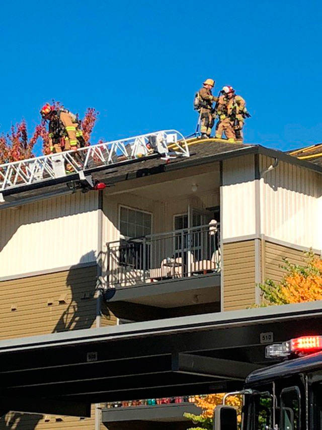 Firefighters from five departments work fast to contain the apartment fire to one unit. Photo courtesy of the Bothell Fire Department