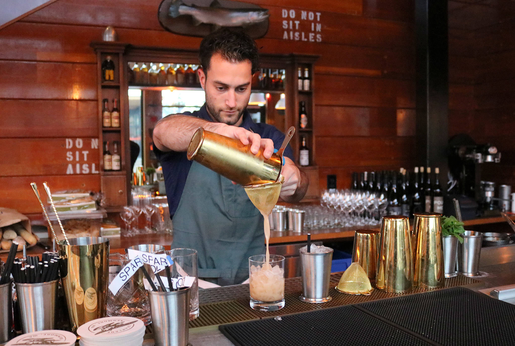 Seaplane bartender JT Goodman makes a cocktail during happy hour on Nov. 26. Katie Metzger/staff photo