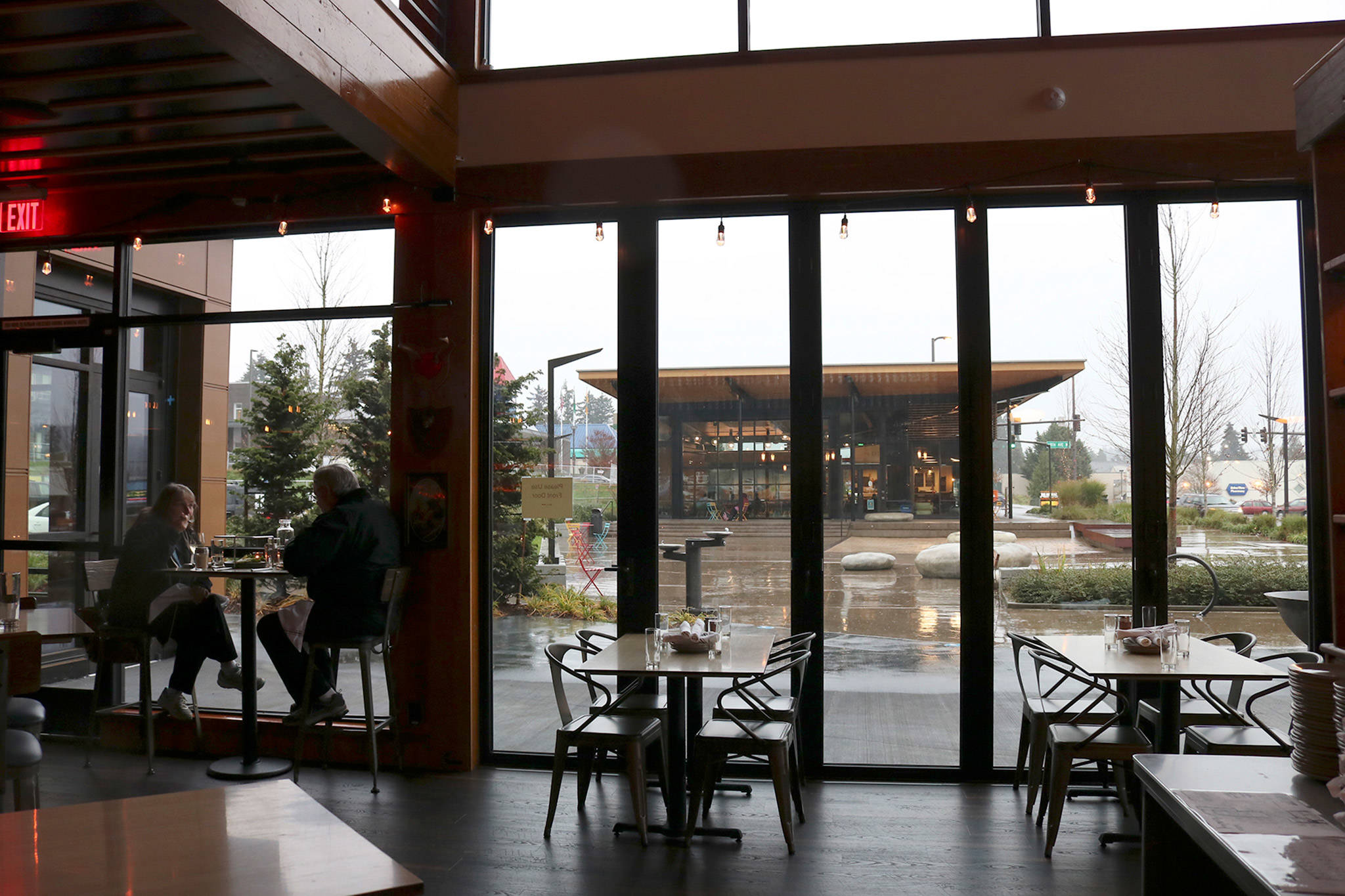 A couple enjoys happy hour on a rainy afternoon at Seaplane Restaurant and Bar, across from the Hangar in downtown Kenmore. Katie Metzger/staff photo