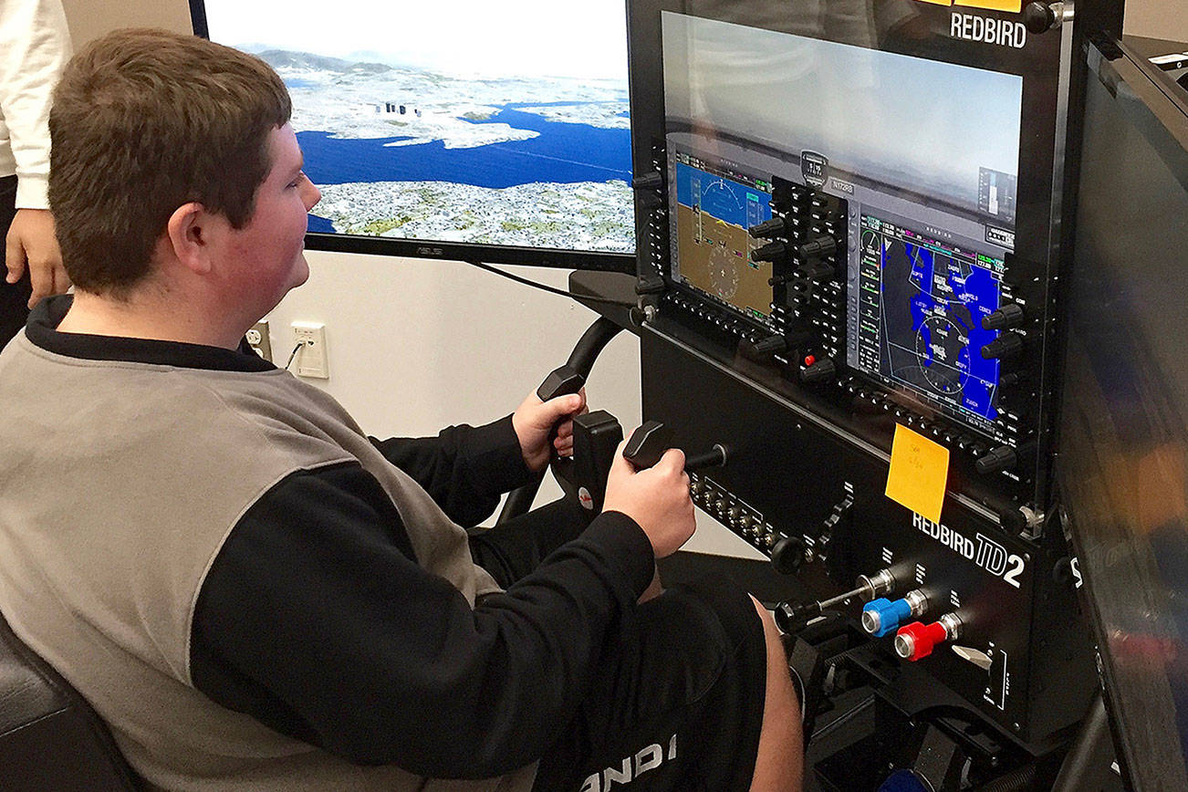 North Creek High School junior Austin Mitchell learns to fly using a $14,000 Redbird flight simulator in Northshore School District’s new Introduction to Aviation class. Photo courtesy of Northshore School District.
