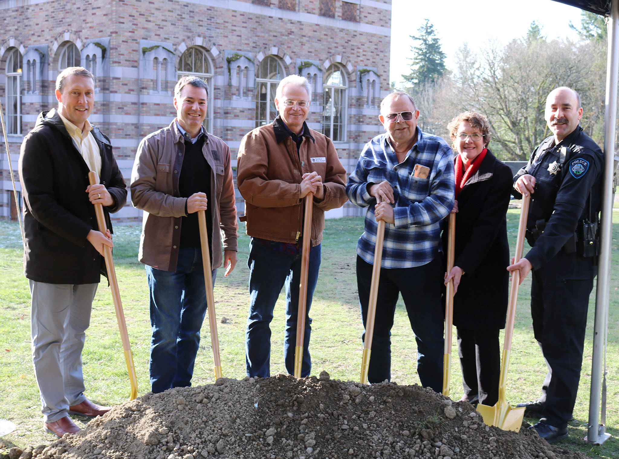 Kenmore city staff, including City Manager Rob Karlinsey, Assistant City Manager Nancy Ousley, Police Chief Peter Horvath, smile with Kevin Daniels and Mayor David Baker at the ceremonial groundbreaking for the Lodge at Saint Edward Park on Dec. 7. Katie Metzger/staff photo