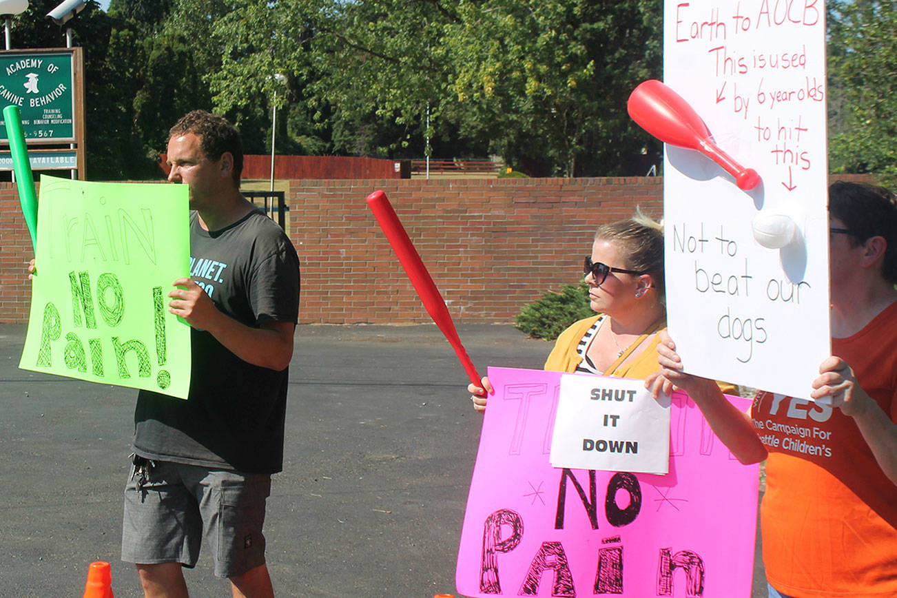 Protesters gathered on July 27 outside Bothell’s Academy of Canine Behavior in response to a video showing a trainer using a plastic bat to hit a dog. Aaron Kunkler/staff photo