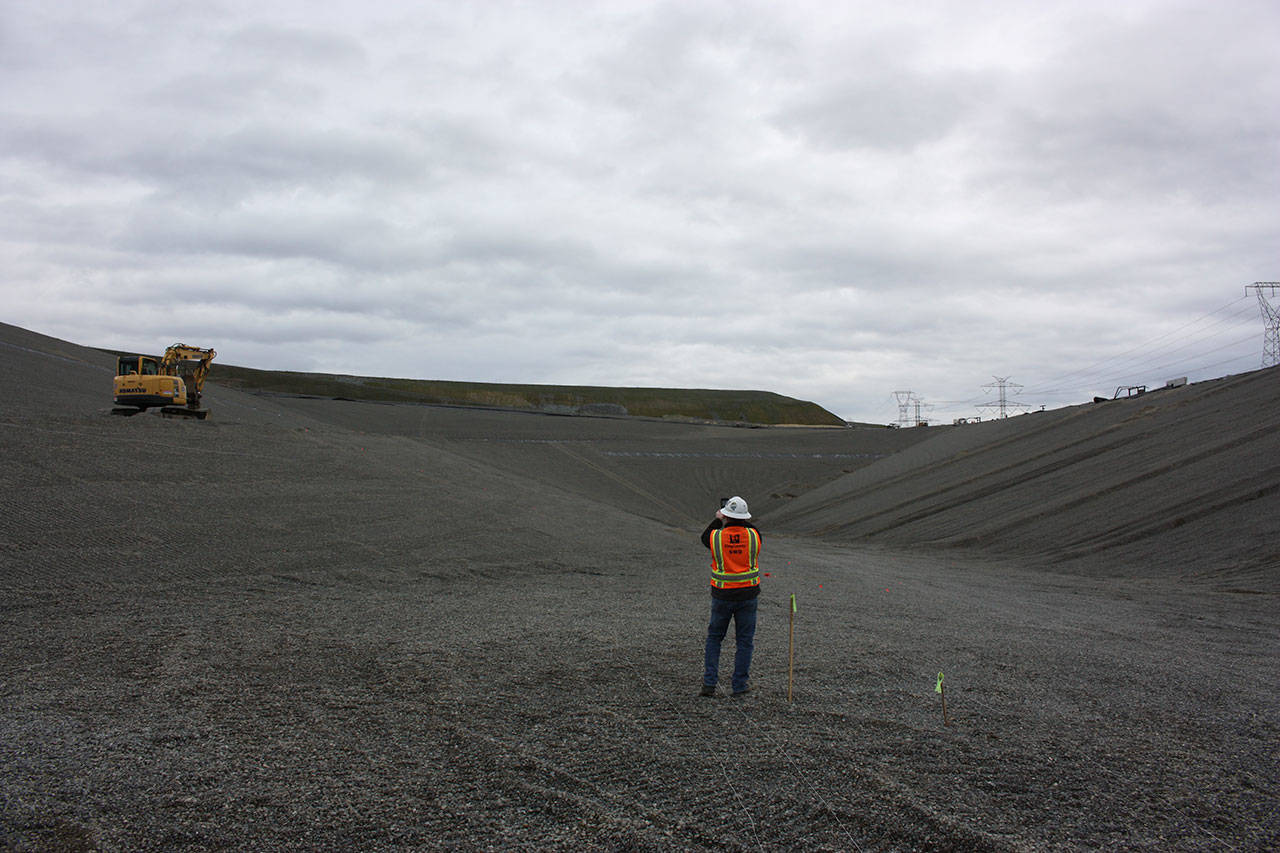 Scott Barden stands at the bottom of the massive pit of the landfill’s newly-built eighth section. Work on the new section has been underway for around two years. Photo by Aaron Kunkler