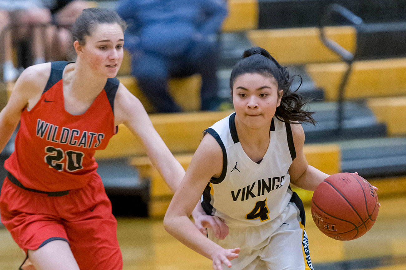Inglemoor freshman Sofia Pequignot, right, attacks the basket while being guarded by Wildcats junior forward Molly Wilbourne, right, on Feb. 7 at Inglemoor High School in Kenmore. Photo courtesy of Patrick Krohn/Patrick Krohn Photography