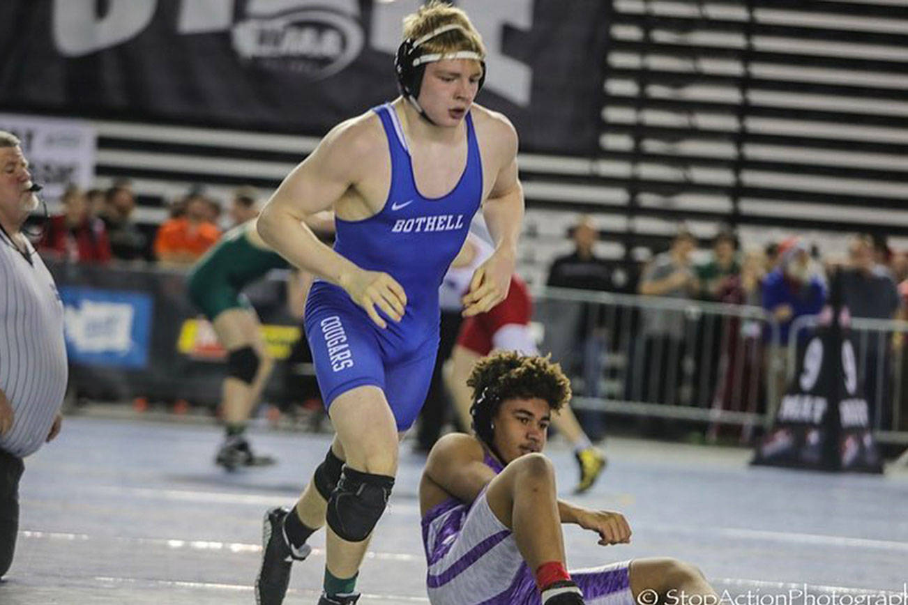 Bothell Cougars wrestler Jay Smith, left, pinned North Creek’s Damon Wallace, right, in just 40 seconds in the first round of the Class 4A state wrestling tournament in the 182-pound weight division on Feb. 15 at the Tacoma Dome. Smith had an overall record of 2-2 at the tourney. Photo courtesy of Don Borin/Stop Action Photography