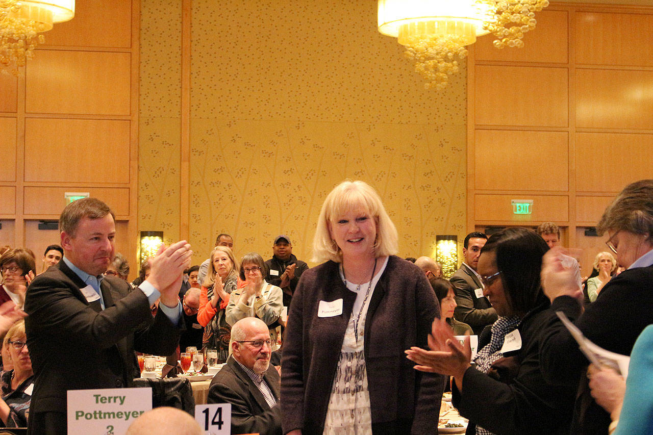 Outgoing Friends of Youth CEO, Terry Pottmeyer, receives a standing ovation at the Celebration of Youth luncheon. Madison Miller/staff photo.