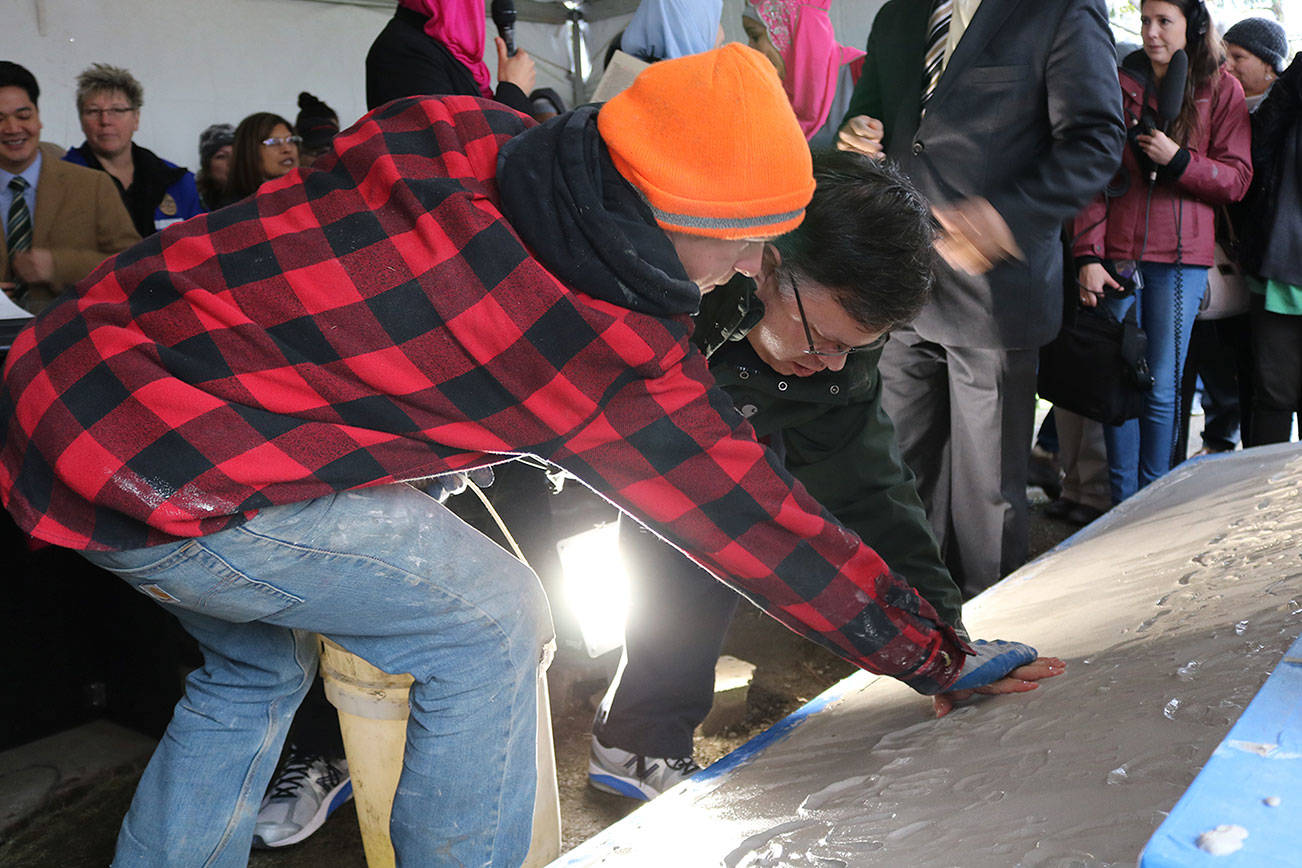 Mayor John Marchione was among many community members to place their handprints in the wet cement below the new sign at the Muslim Association of Puget Sound in Redmond after the mosque’s old sign was vandalized in 2016. File photoMAPS Sign