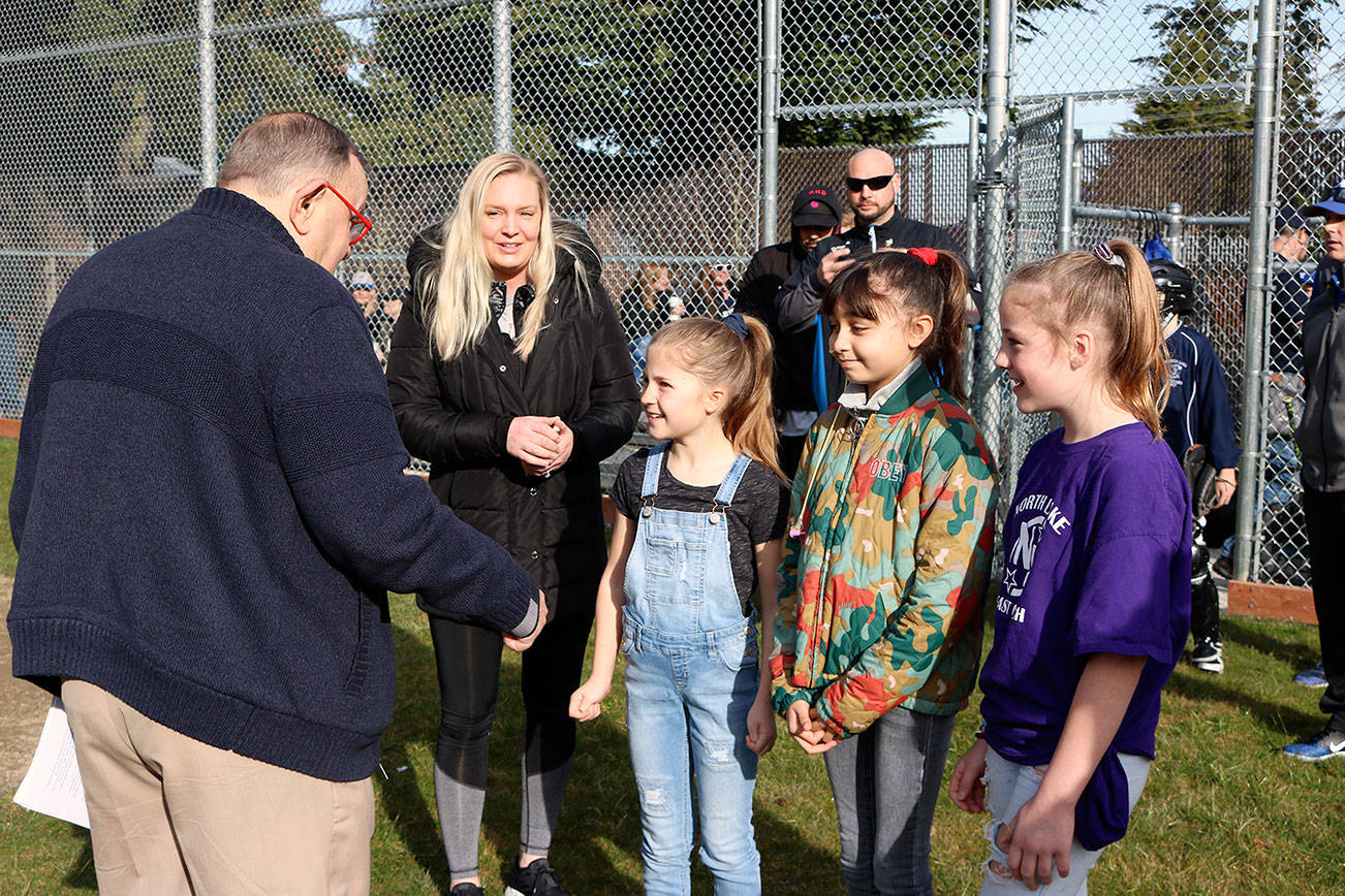 Violet Martinez and her two friends on either side meet Kenmore Mayor David Baker shortly before throwing the first pitch at Moorlands Park. Violet has Lymphoma and has begun to lose her hair after recently finishing her second round of chemo. Photo courtesy of Kenmore