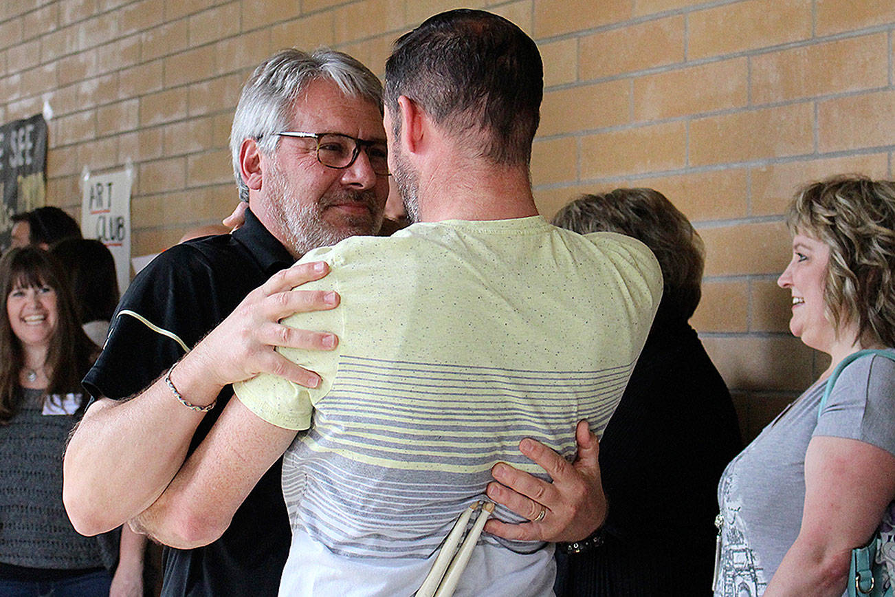 IHS Ted Christensen reconnects with old students at his surprise retirement celebration on June 9. Madison Miller / staff photo