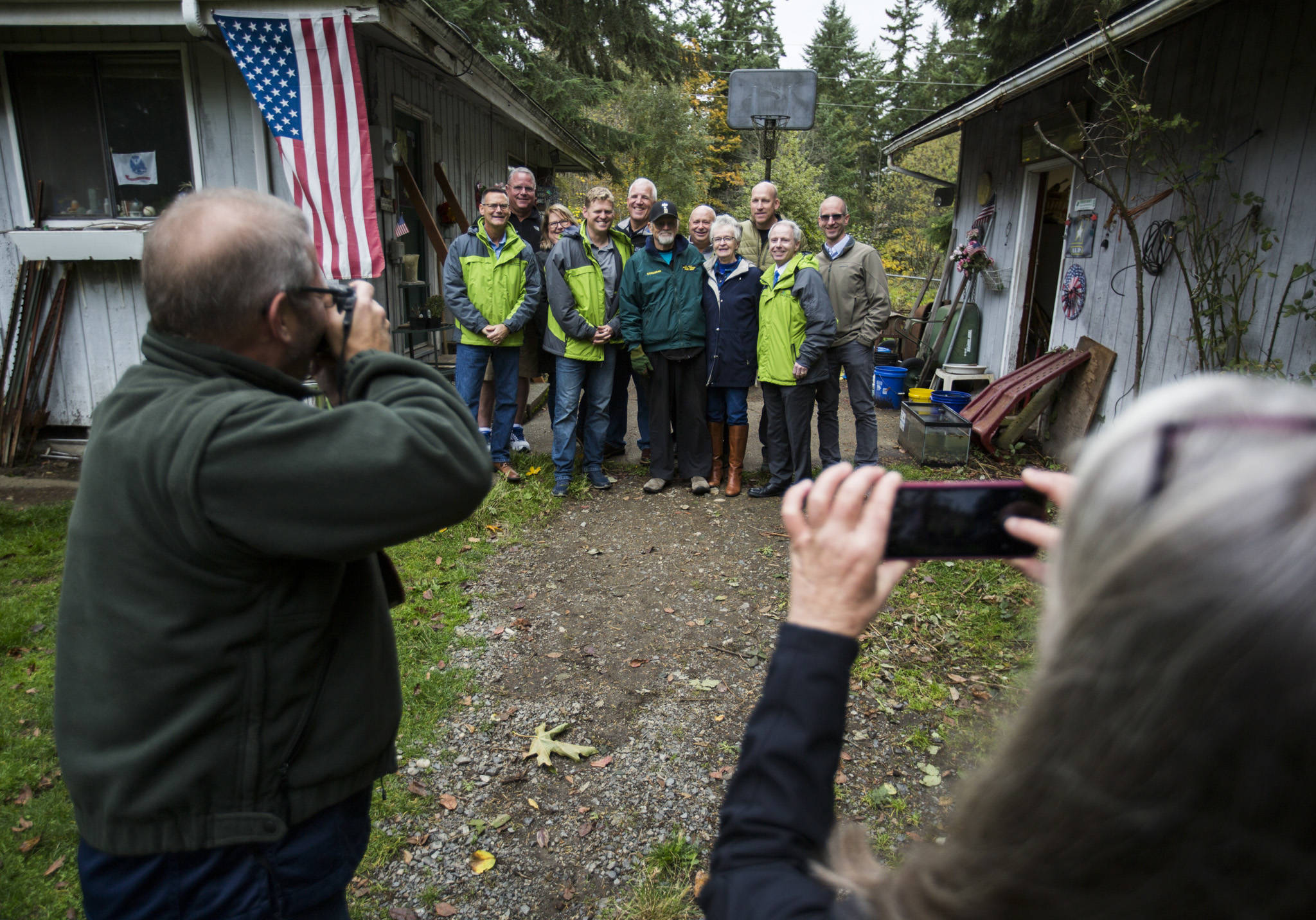 A group of friends, family and Snohomish County officials gather for a group photo at Jim Corcoran’s home in Bothell on Oct. 18. Olivia Vanni/staff photo