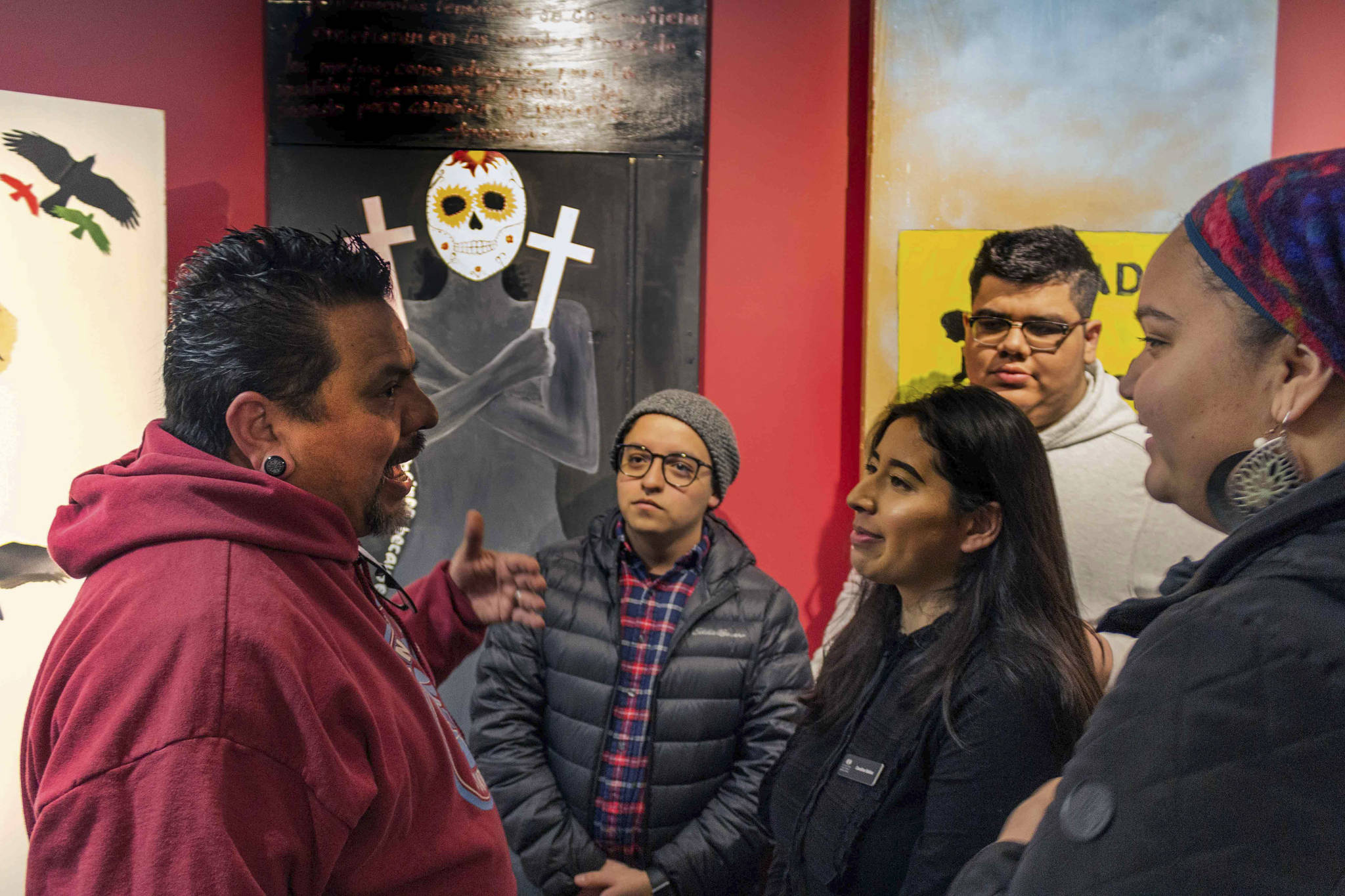 Photo courtesy of Centro Cultural Mexicano                                Claudio Pérez speaks with a group of students at the opening reception for the “Border Doors” exhibit at Centro Cultural Mexicano.