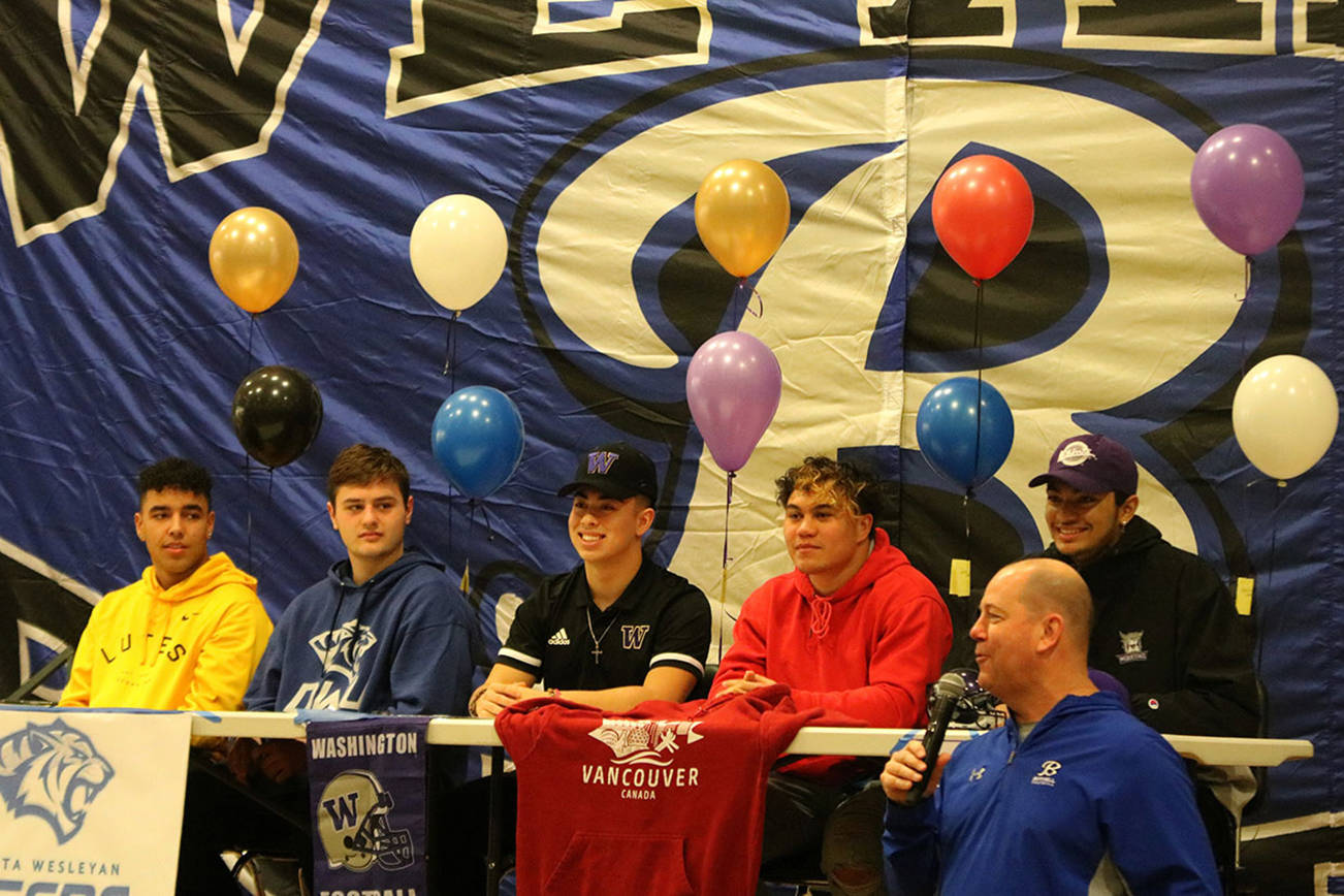 Bothell High head football coach Tom Bainter speaks about his Cougar players, from left to right: Chris Bailey, Trent Suckut, Christian Galvan, Tala Tevaga and Jordyn Turner. Andy Nystrom/ staff photo