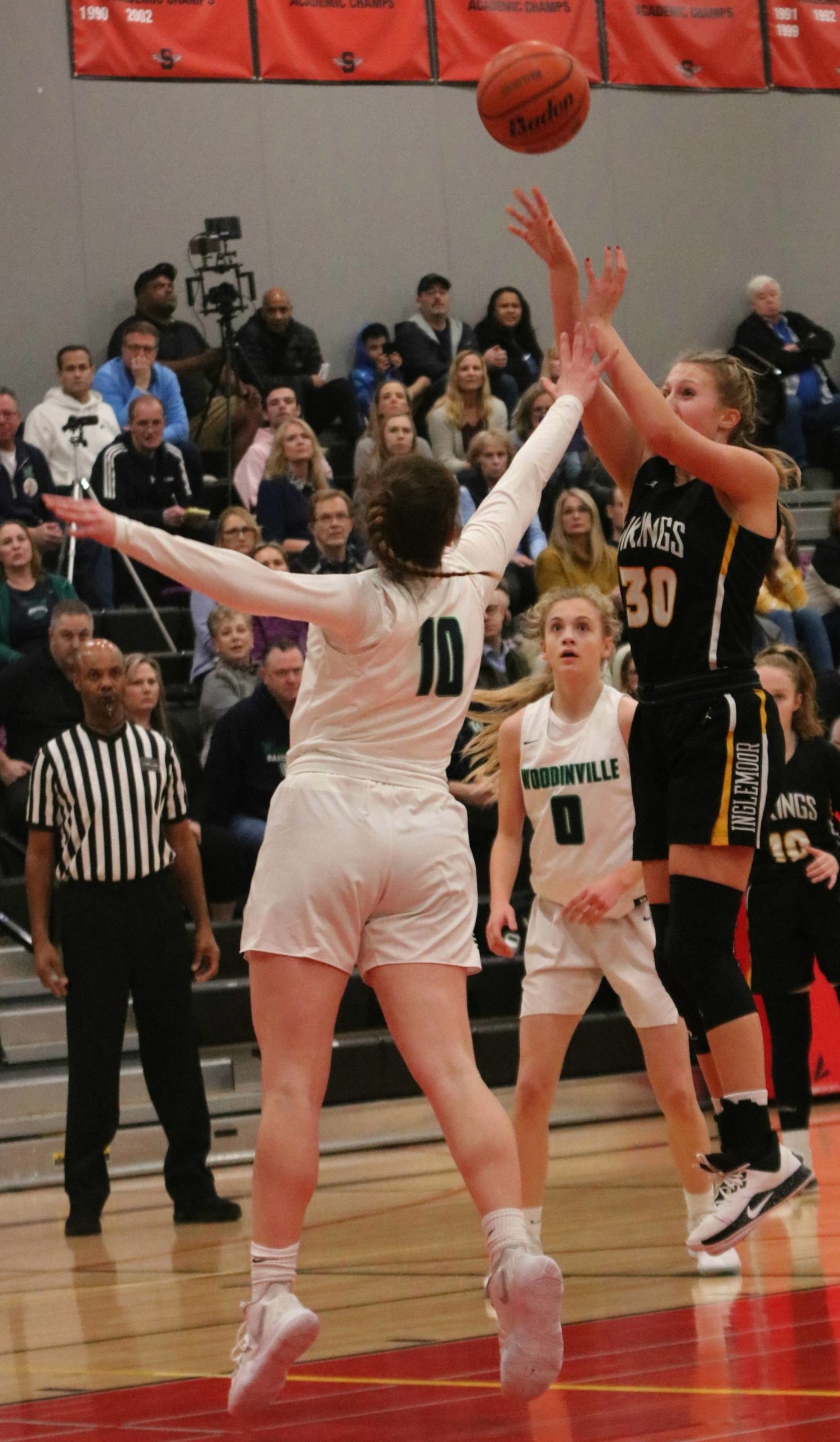Inglemoor’s Abby Haller (right) fires away against Woodinville. Andy Nystrom/ staff photo