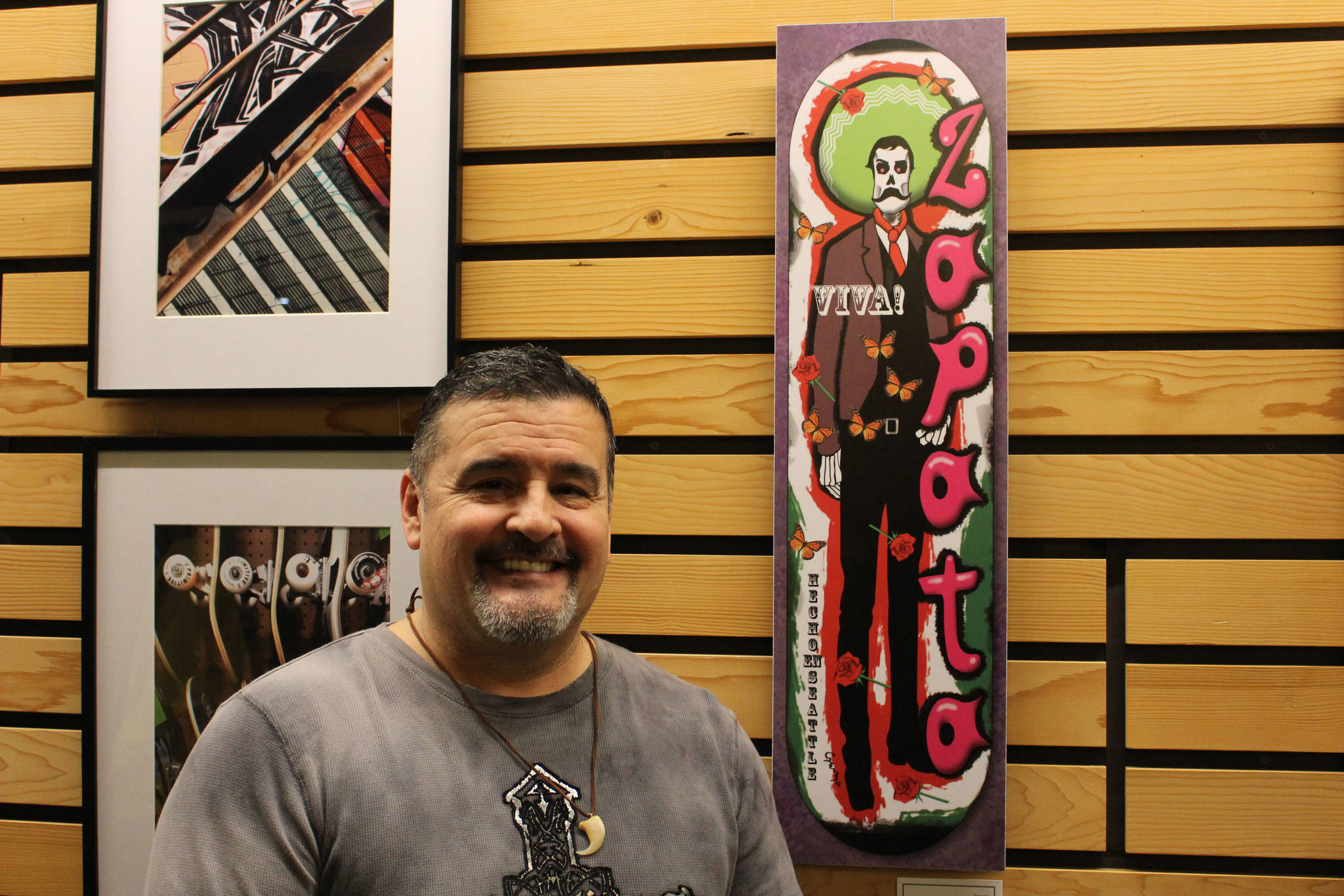 Mitchell Atencio/staff photo                                William Garza poses with his piece “Zapata” at the Skater Park Street Art Exhibit at City Hall in Kenmore on Feb. 7.