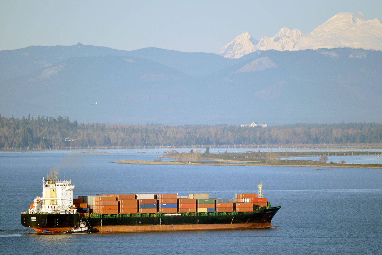 With Mount Baker and Jetty Island in the distance, a container ship approaches the Port of Everett. (Port of Everett photo)