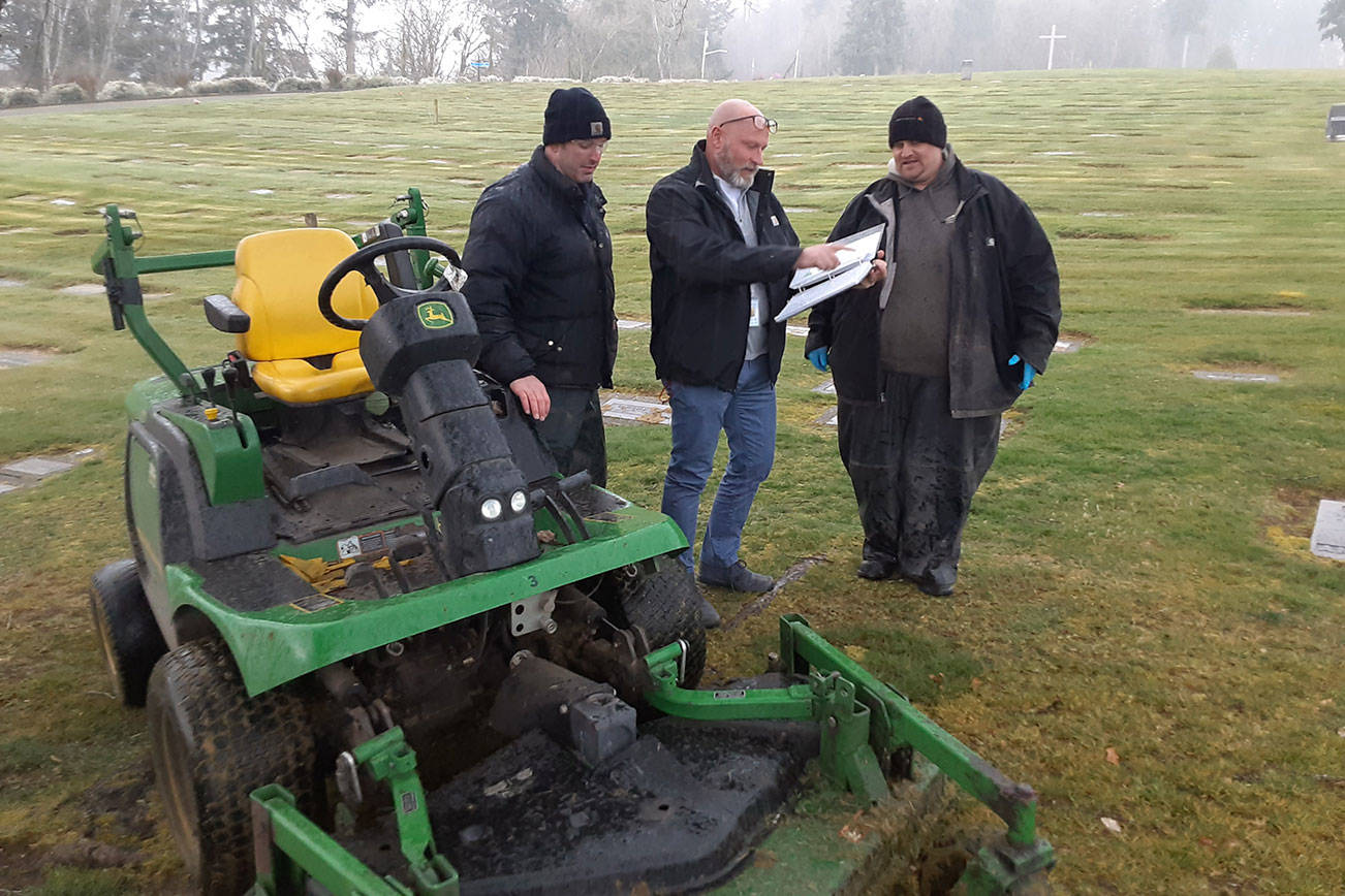 Auburn Mountain View Cemetery Manager Craig Hudson, center, confers with maintenance workers David Partridge, left, and Zach Hopper in March 2020. Sound Publishing file photo