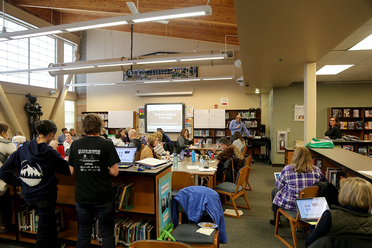 Staff at Canyon Park Middle School in Bothell receive training, March 5, 2020, on online learning options. Now the return to school in the fall is planned to also be online-only. (Courtesy Northshore School District)