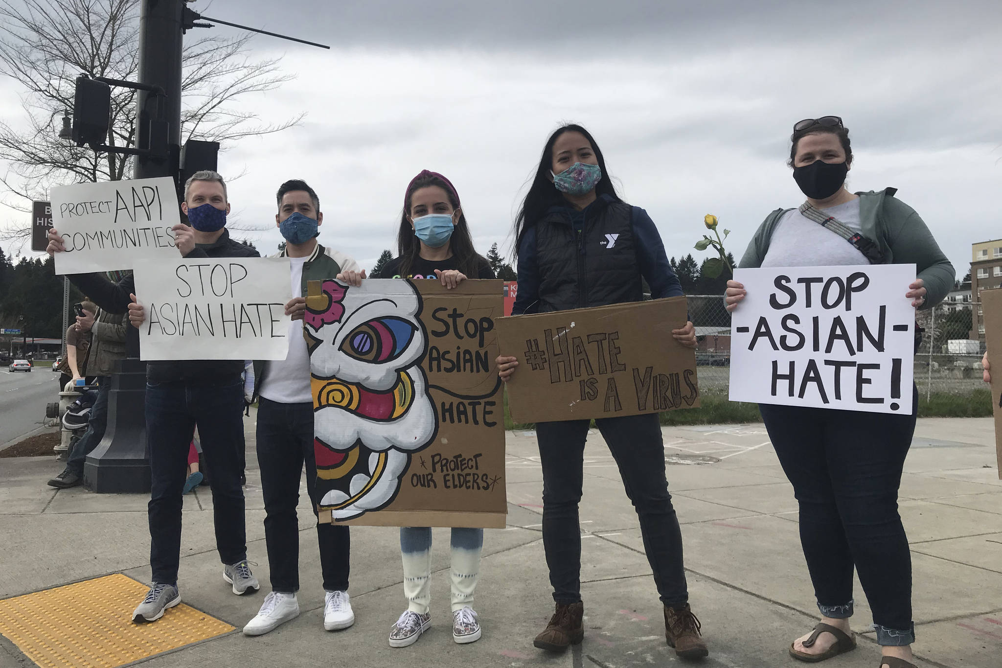 Rally participants hold signs in support of AAPI community (photo credit: Cameron Sheppard)