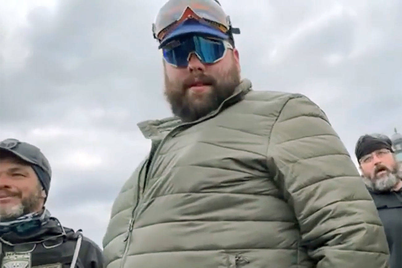 Daniel Scott (center, in green jacket) and Eddie Block (bottom right) are shown in a video before the Proud Boys and other rioters stormed the U.S. Capitol building on Jan. 6 in Washington, D.C.