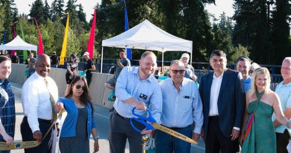 Mayor Nigel Herbig smiles as he cuts the ribbon at the West Sammamish River Bridge grand opening celebration on August 11. Courtesy of the City of Kenmore.