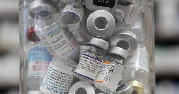 A jar full of empty COVID-19 vaccine vials is shown at the Junction Chemist pharmacy during the COVID-19 pandemic in Toronto on Wednesday, April 6, 2022. As the U.K. has kicked off the global race to greenlight an updated version of the COVID-19 vaccine, anticipation is mounting for Canada to follow suit as fall threatens to usher in a new wave of infections. THE CANADIAN PRESS/Nathan Denette