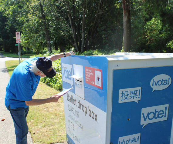 A man places his ballot into the drop box outside Federal Way City Hall. Bailey Jo Josie/Sound Publishing