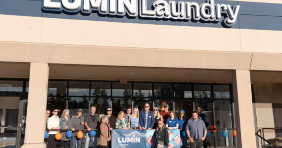 Lumin Laundry owners and staff gathered with the Edmonds Chamber of Commerce for the ribbon cutting at their grand opening. Photo courtesy Lumin Laundry.