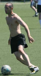 Soccer was the name of the game in the 80-degree weather at lunchtime last Thursday at North Creek Sportsfields in Bothell. James Tassani gets his kicks during the match. Players meet regularly at lunch during the week for the pick-up games.
