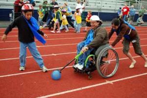 Tom Carnaham races down the track with the help of other blue team members during last year's Wacky Wheelays.