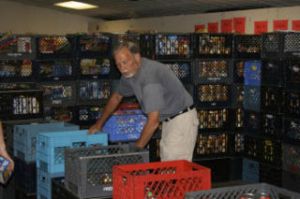 Northshore food bank volunteer Tim Williams helps sort food stuffs at the Hopelink in Bothell