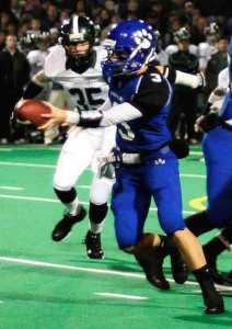 Bothell High quarterback Mitchell Muller hands the ball off during the Cougars' 4A Kingco championship victory last week against Skyline High.