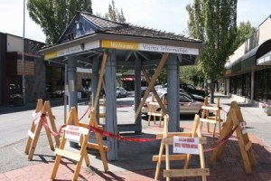 Once shelter to bus riders and home to a clock and community bulletin board
